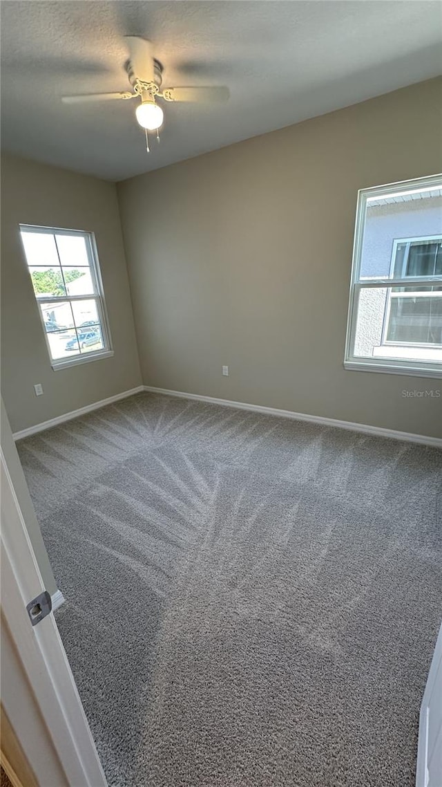 carpeted empty room with ceiling fan