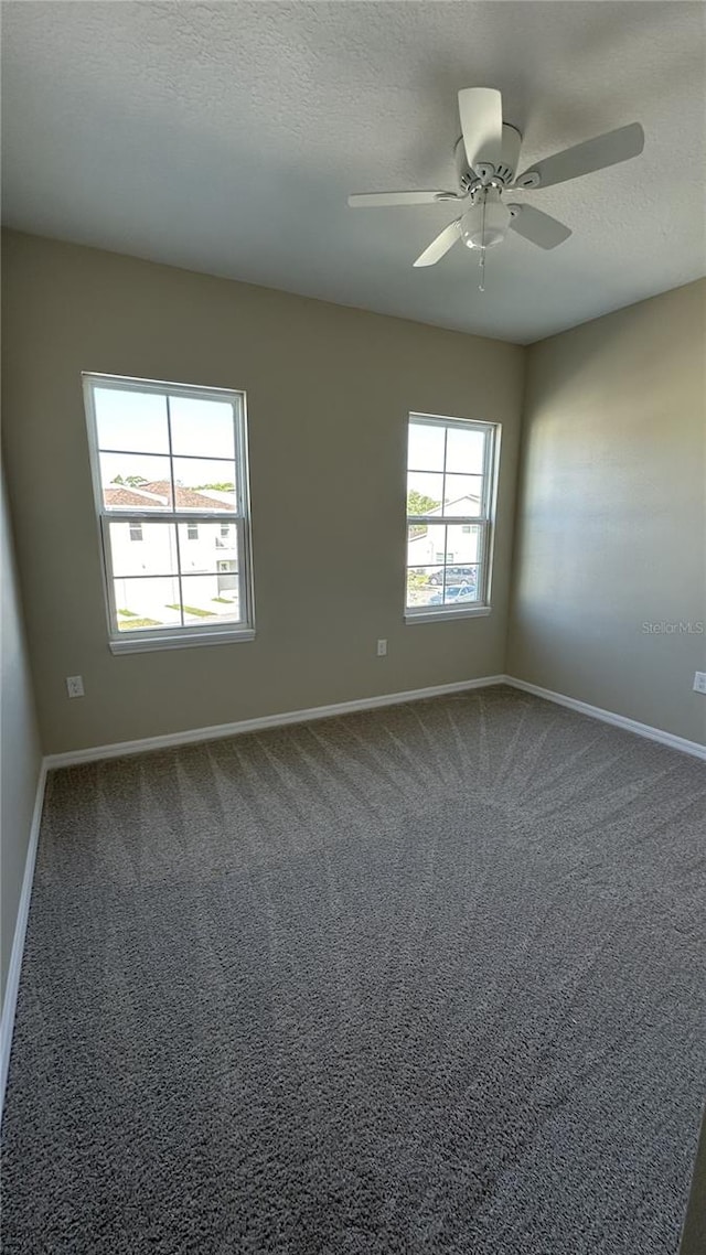 carpeted empty room with ceiling fan