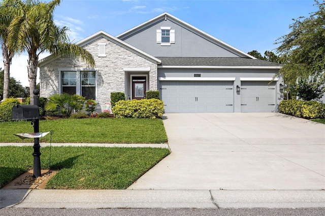 view of front of property featuring a garage and a front yard