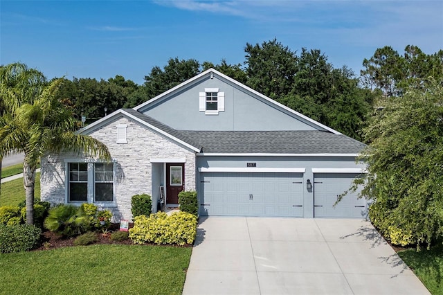 view of front of property with a garage and a front lawn