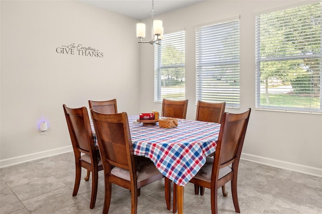 dining space with tile floors and a notable chandelier