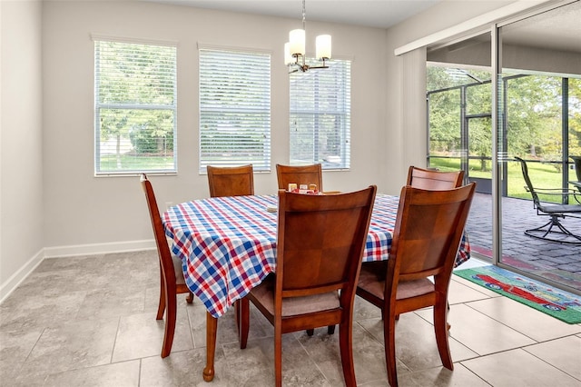 dining room featuring tile flooring, an inviting chandelier, and a wealth of natural light