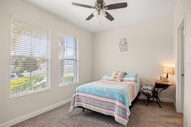 carpeted bedroom with ceiling fan and multiple windows