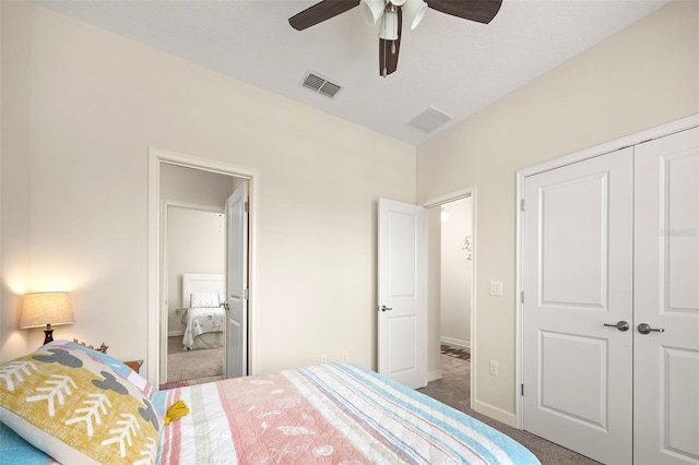 carpeted bedroom with ceiling fan and a closet