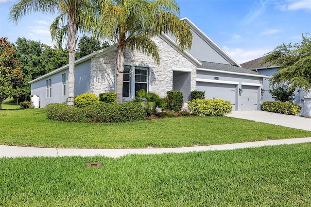 view of front of property featuring a front lawn and a garage