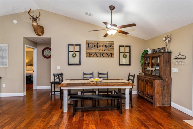 dining area with ceiling fan, lofted ceiling, and dark hardwood / wood-style flooring