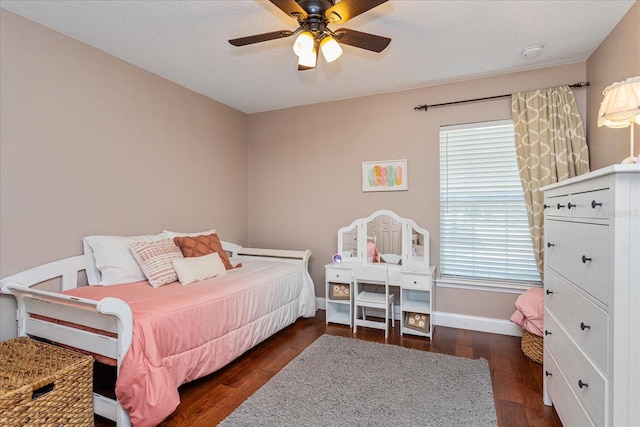 bedroom with dark hardwood / wood-style flooring and ceiling fan