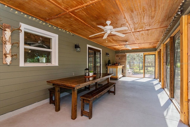 sunroom featuring wooden ceiling and ceiling fan