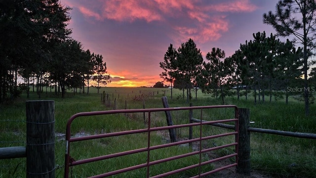 gate at dusk with a rural view