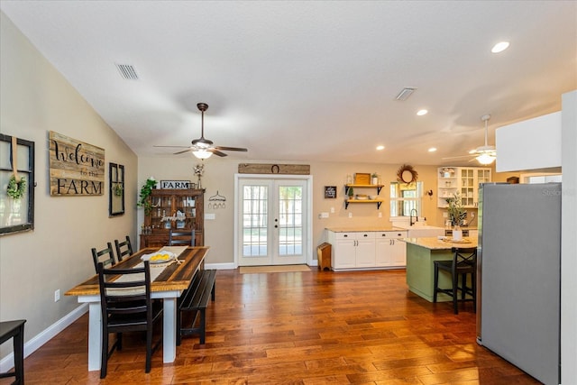 dining space featuring lofted ceiling, sink, dark wood-type flooring, ceiling fan, and french doors