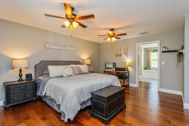 bedroom with dark wood-type flooring, a textured ceiling, and ceiling fan