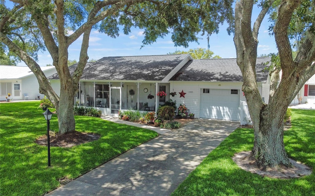 ranch-style home featuring a front yard and a garage