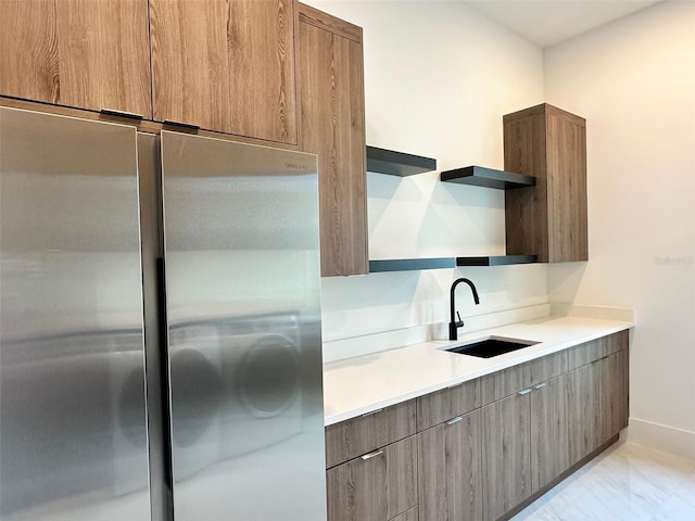 kitchen with sink and stainless steel refrigerator