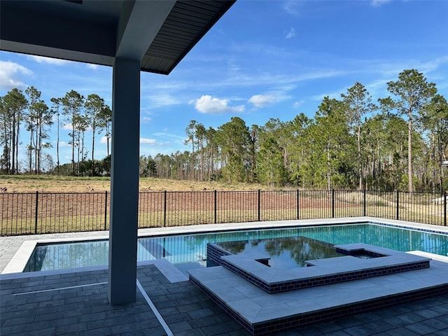 view of pool with an in ground hot tub