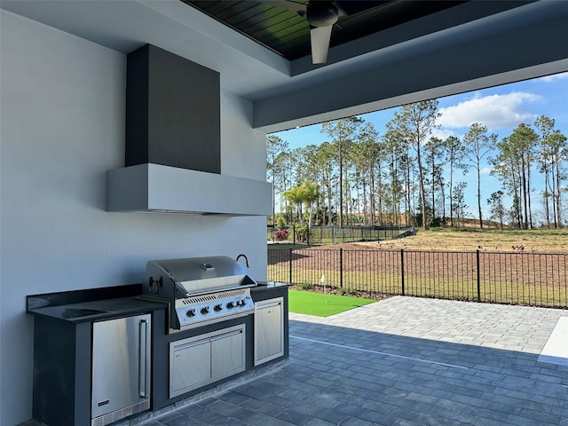 view of patio / terrace with exterior kitchen, ceiling fan, and grilling area