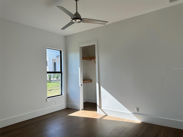 spare room with dark hardwood / wood-style floors and ceiling fan