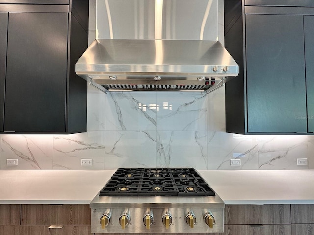 kitchen with wall chimney exhaust hood, stainless steel gas cooktop, and decorative backsplash