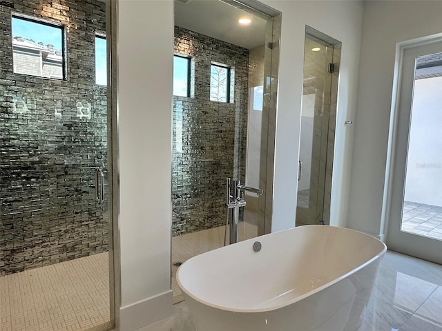 bathroom featuring separate shower and tub and sink