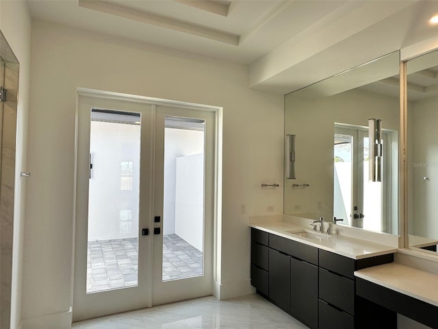 bathroom with vanity, a tray ceiling, and french doors