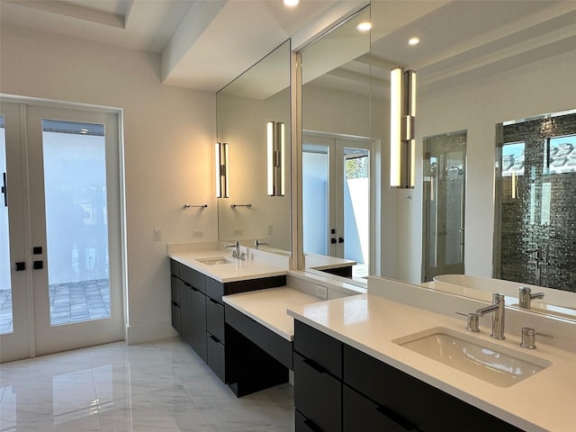 bathroom featuring vanity, walk in shower, and french doors