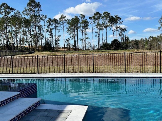 view of swimming pool featuring a yard