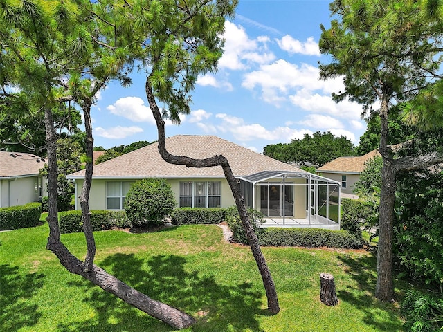 ranch-style house featuring a lanai and a front yard