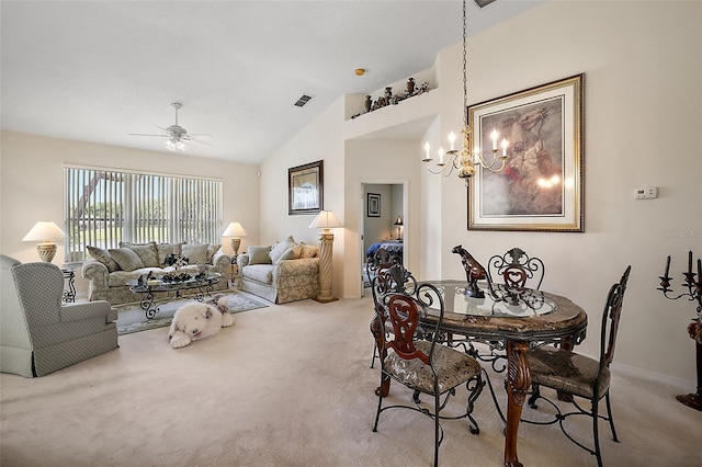 carpeted dining area featuring ceiling fan with notable chandelier and vaulted ceiling