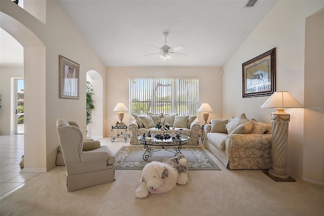 living room with light carpet, a textured ceiling, ceiling fan, and lofted ceiling