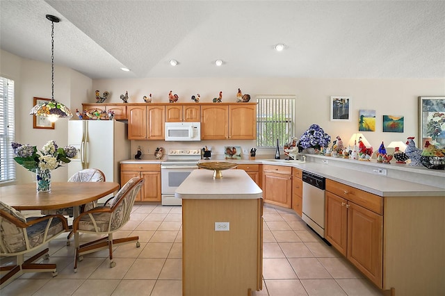 kitchen featuring a textured ceiling, white appliances, decorative light fixtures, and plenty of natural light