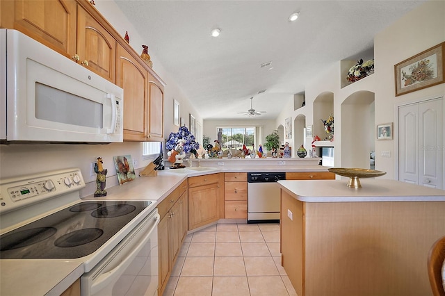 kitchen featuring ceiling fan, a center island, vaulted ceiling, white appliances, and light tile patterned floors