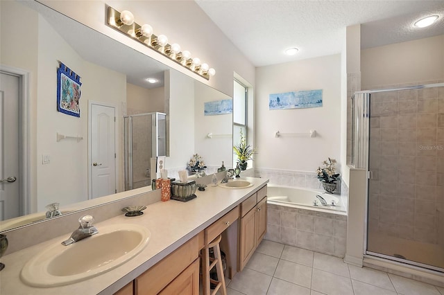 bathroom featuring tile patterned flooring, plus walk in shower, vanity, and a textured ceiling