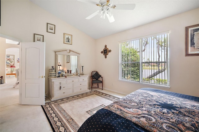 bedroom featuring light carpet, a textured ceiling, ceiling fan, and lofted ceiling