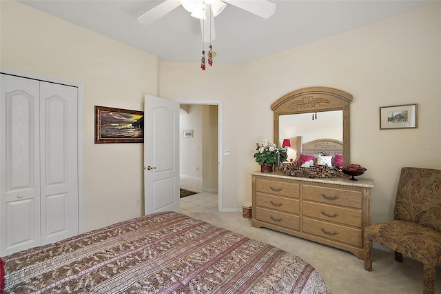 carpeted bedroom featuring ceiling fan and a closet