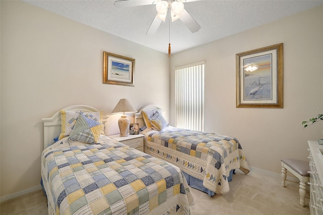 carpeted bedroom featuring a textured ceiling and ceiling fan