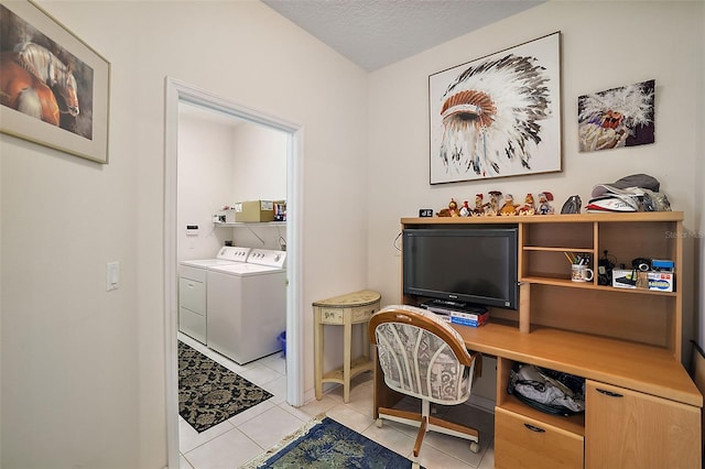 tiled office space featuring a textured ceiling and separate washer and dryer