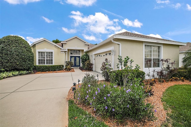 ranch-style house featuring french doors and a garage