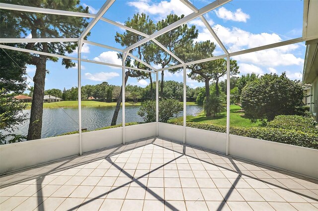 unfurnished sunroom featuring a water view