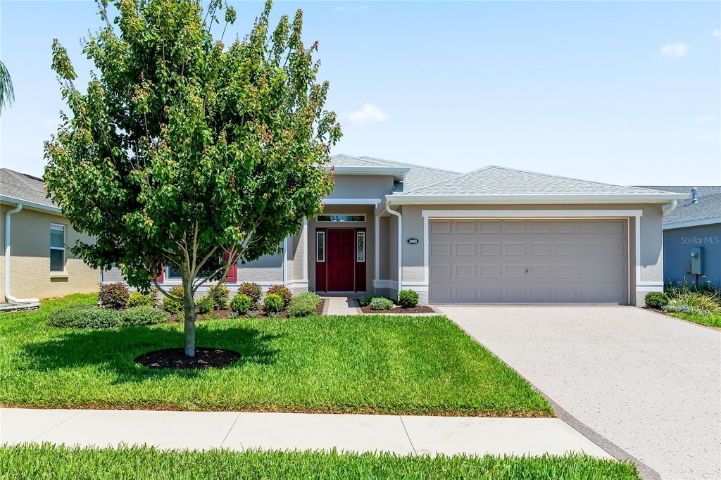 view of front of home featuring a garage and a front lawn