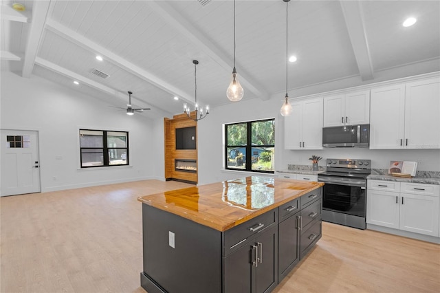 kitchen featuring white cabinetry, light hardwood / wood-style floors, wood counters, vaulted ceiling with beams, and stainless steel appliances