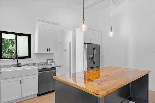 kitchen featuring light hardwood / wood-style floors, white cabinets, butcher block countertops, and stainless steel appliances