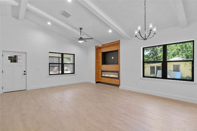 unfurnished living room featuring beam ceiling, ceiling fan with notable chandelier, a large fireplace, and light wood-type flooring