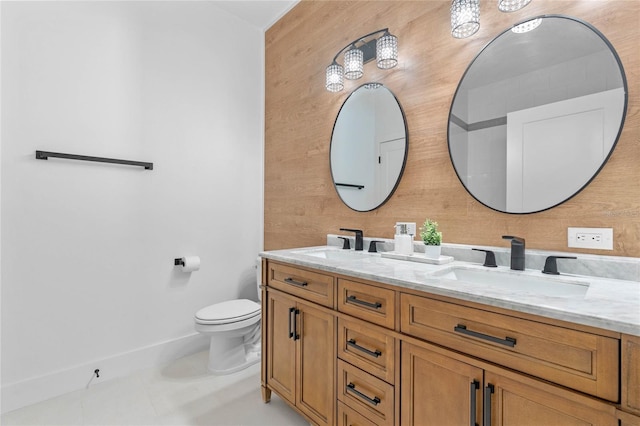 bathroom featuring dual vanity, toilet, and tile floors