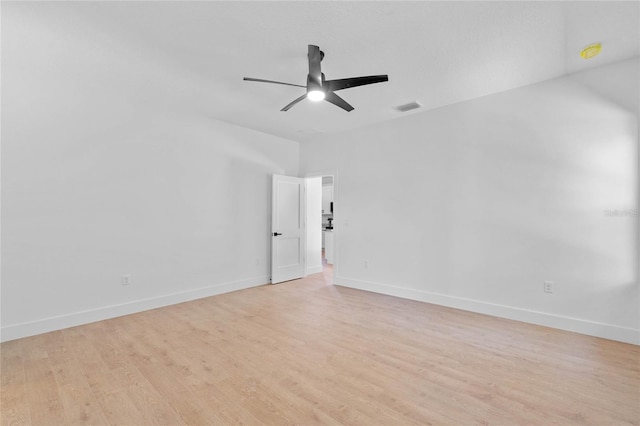 spare room featuring light hardwood / wood-style floors and ceiling fan