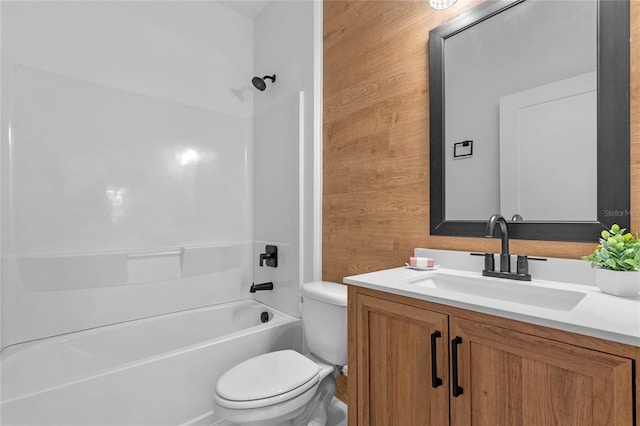 full bathroom featuring toilet, wooden walls, vanity, and bathing tub / shower combination