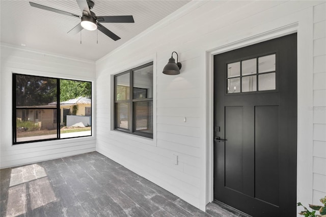 view of exterior entry featuring ceiling fan