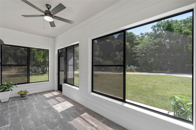 unfurnished sunroom with a wealth of natural light and ceiling fan