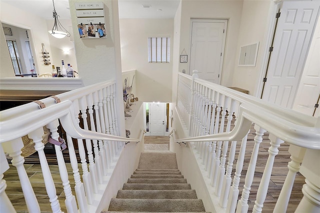 staircase with hardwood / wood-style flooring