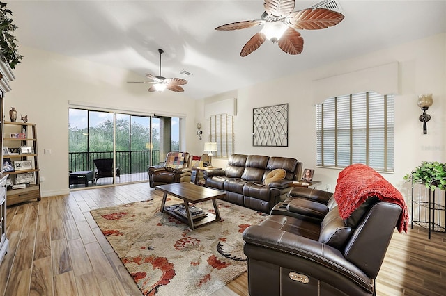 living room featuring wood-type flooring and ceiling fan