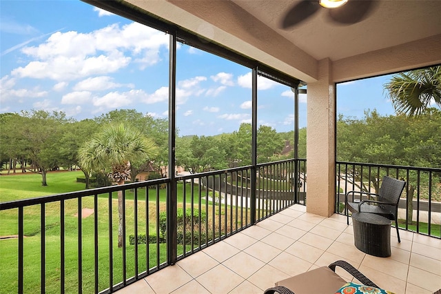 unfurnished sunroom featuring ceiling fan