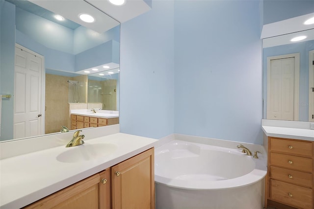 bathroom featuring vanity and plus walk in shower